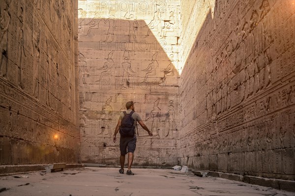 A young tourist visiting the beautiful temple of Edfu in the city of Edfu