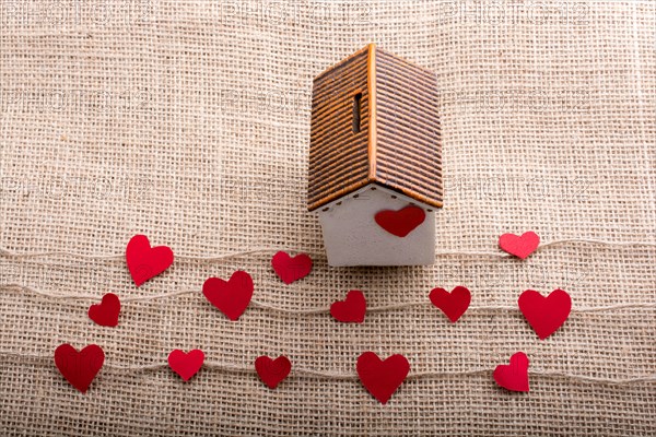 Heart shaped icons and paper house on linen threads