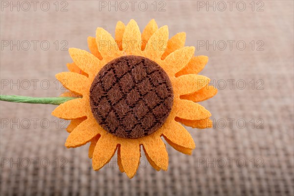 Fake flower placed on brown background