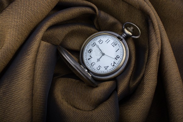 Mechanical retro styled pocket watch on fabric