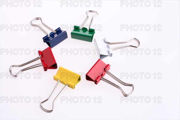 Colored paper clips on a white background