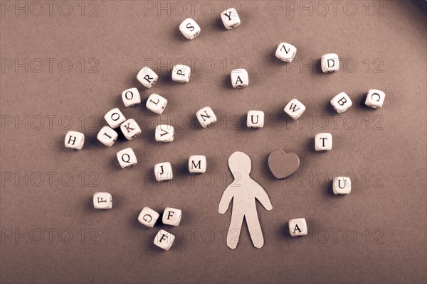 Letter cubes of made of wood and man figurine and heart shape