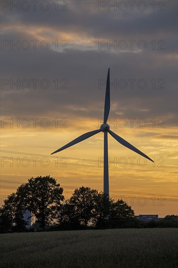 Wind power plant in front of evening sky