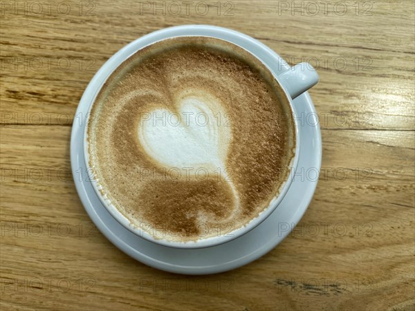 Cup of cappuccino with milk foam in the shape of a heart