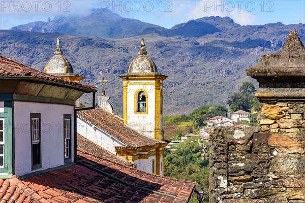 Historical baroque church with mountains in the background in Ouro Preto city in Minas Gerais