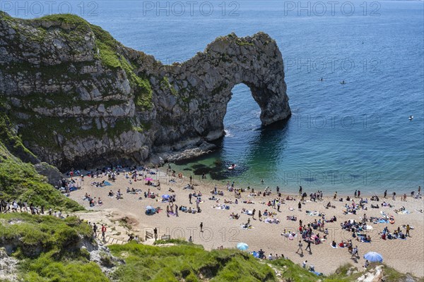 Bathing beach at the famous rock bridge Durdledoor