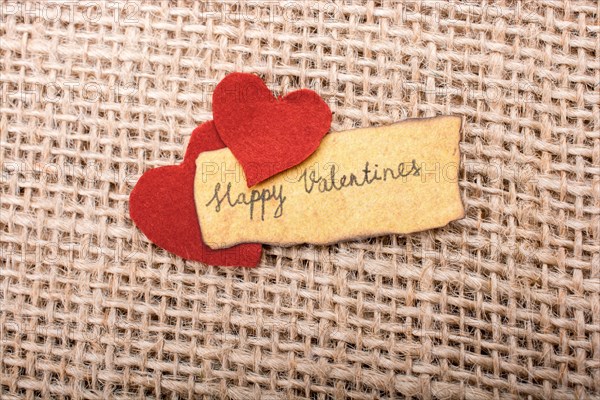 Love icon and Valentine's day wording on torn paper