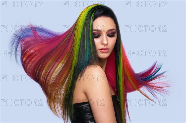 Portrait of beautiful woman with multi-colored hair and creative make up and hairstyle