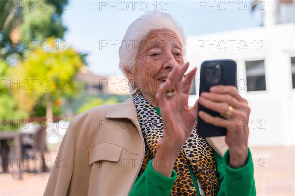 An elderly man in the garden of a nursing home or retirement home on a sunny summer day