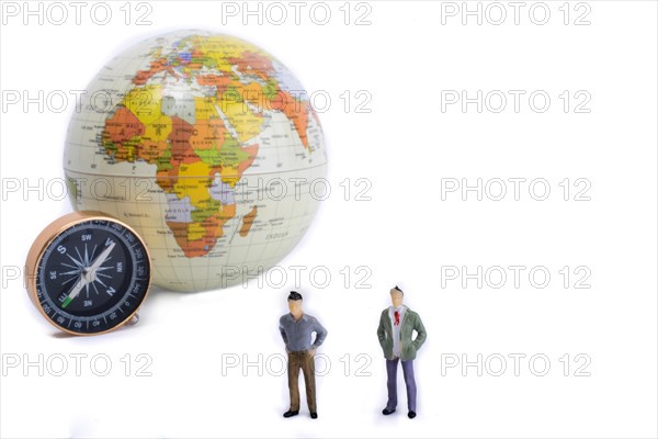 A couple by the side of a globe with a compass on isolated white background