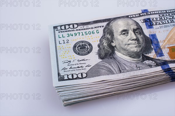 American 100 dollar banknotes made of paper placed on white background