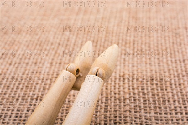 Wooden dolls posing with his legs on canvas