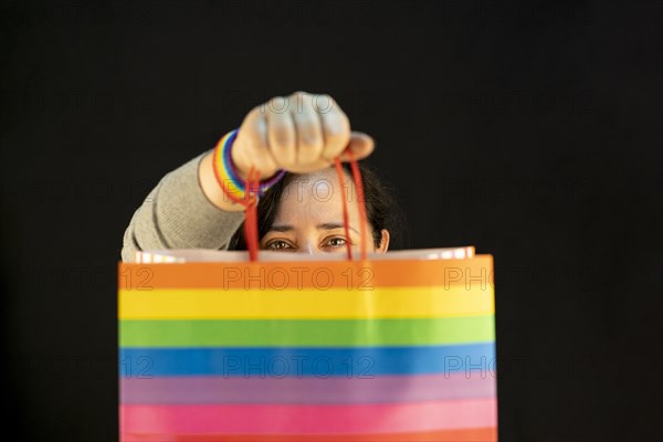 Woman holding lgbt bag. Joy of consumption. Purchases