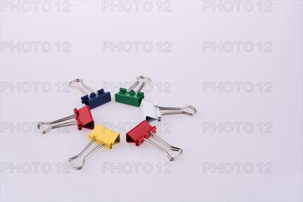 Colored paper clips on a white background