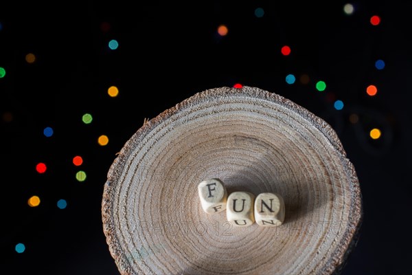 Fun wording on wooden cubes bokeh lighton a dark background