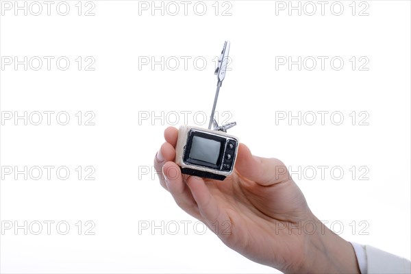 Child holding a tv set n his hand on a white background