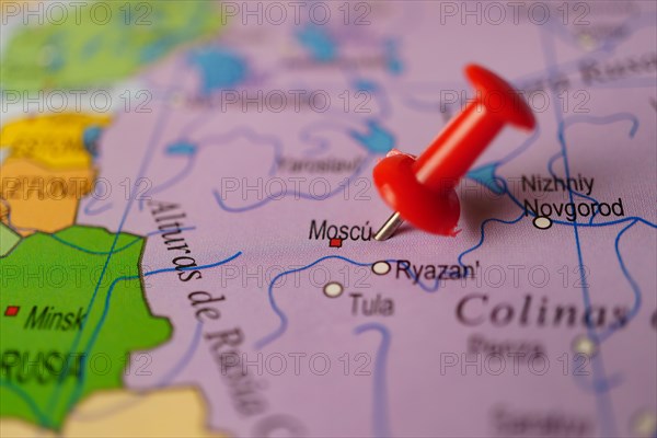 Moscow marked with a red thumbtack on a map with an out-of-focus background