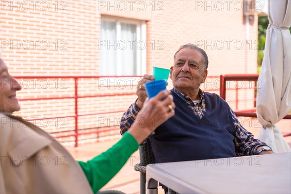 Two elderly people in the garden of a nursing home