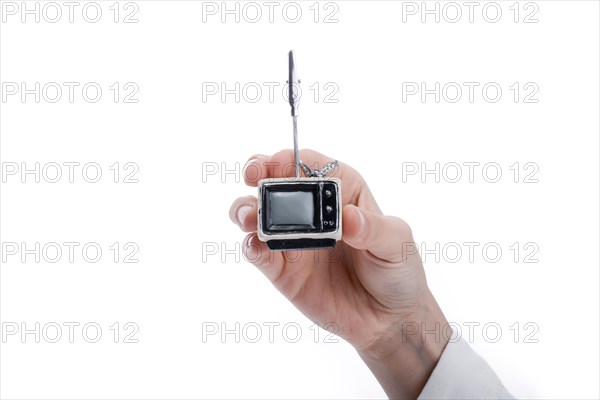 Child holding a tv set n his hand on a white background