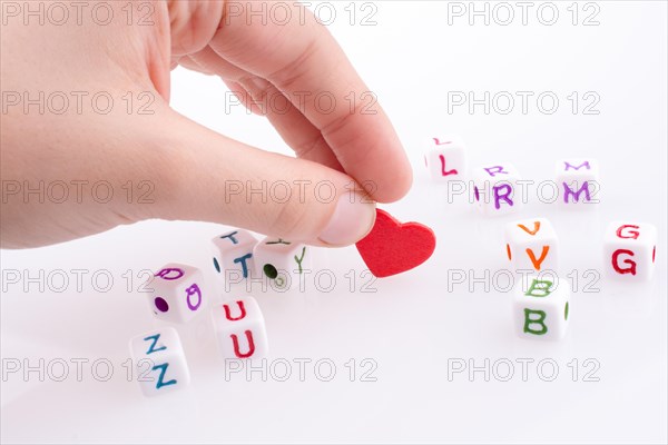 Heart between Letter cubes on a white background