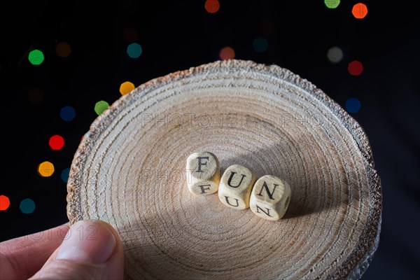 Fun wording in hand cubes bokeh lighton a dark background