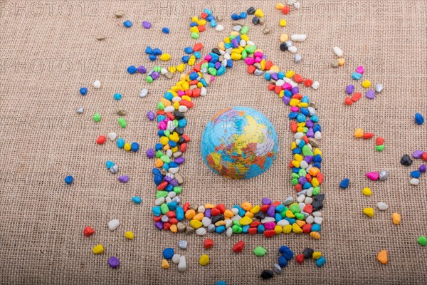 Globe in the house form shaped by colorful pebbles