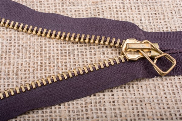 Closeup of a colorful zipper on linen canvas