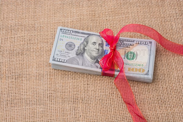 Banknote bundle of US dollar tied with colorful a ribbon