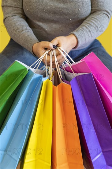 Shopping bags in the woman hands. Joy of consumption. Purchases