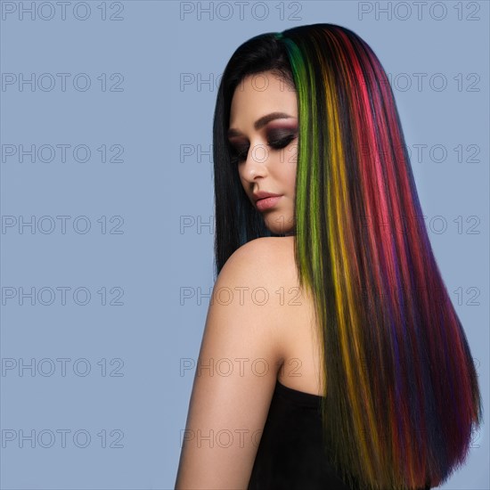 Portrait of beautiful woman with multi-colored hair and creative make up and hairstyle