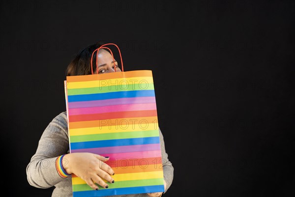 Woman holding lgbt bag. Joy of consumption. Purchases