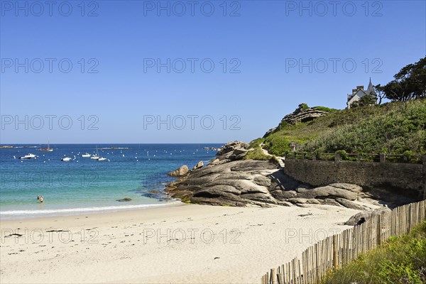 Bay with sandy beach and granite rocks