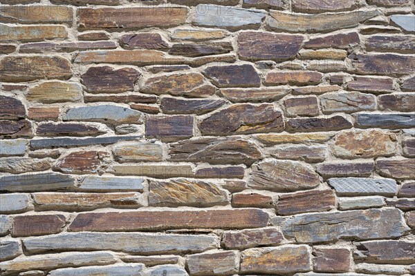 Slate slabs stacked to form a house wall