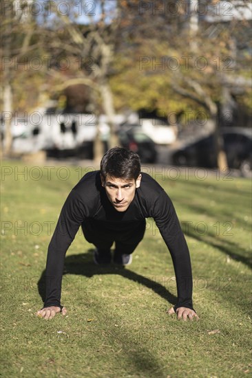 Man doing push ups in the park