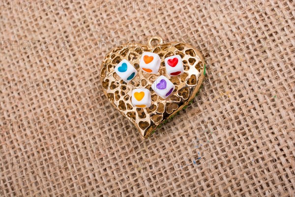 Heart cubes on Heart shaped gold color object