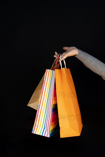 Shopping bags in the woman hands. Joy of consumption. Purchases