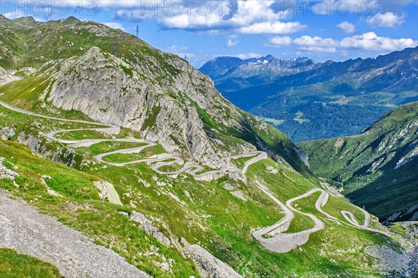 View from elevated position on old southern pass road Tremola south ramp with serpentines tight curves hairpin bends on steep mountain slope of Gotthard Pass