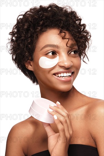 African American skincare models with perfect skin and curly hair with patches under her eyes