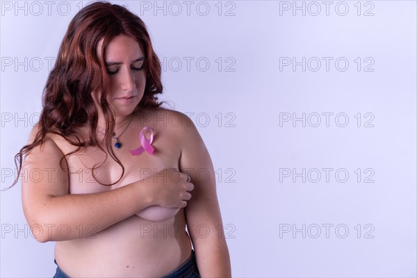 Young woman covering her breasts