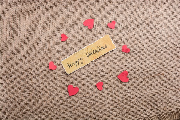 Love icon and Valentine's day wording on torn paper