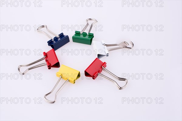 Colored paper clips on a white background