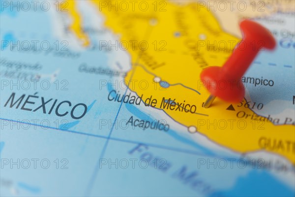 Mexico marked with a red thumbtack on a map with an out-of-focus background