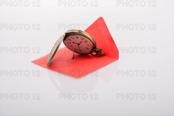 Mechanical pocket watch on a red envelope