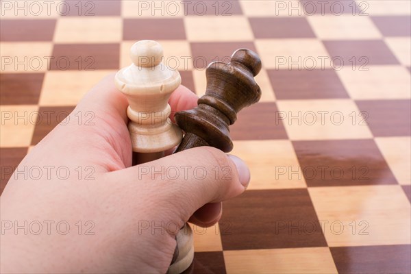 Person playing chess game making a move on board