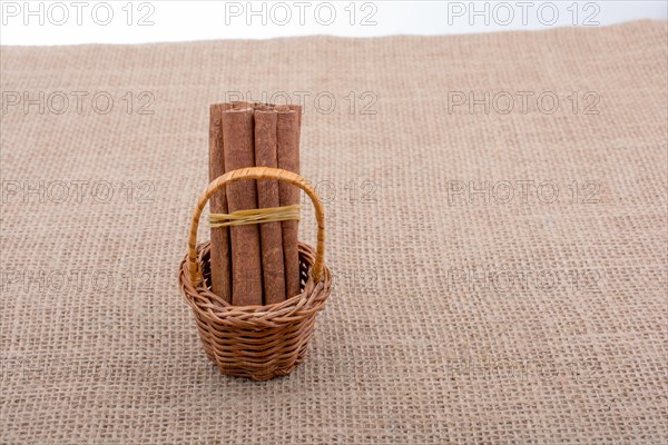 Bundle of cinnamon sticks on a linen canvas background