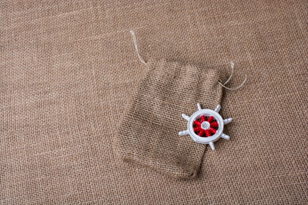 Steering wheel of a boat on a sack on canvas