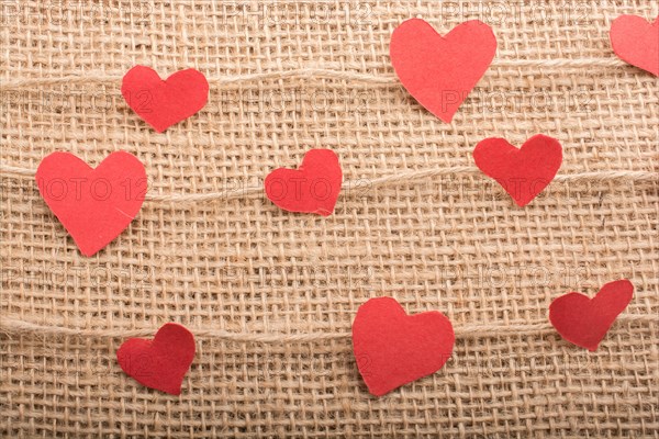 Love concept with heart shaped papers on linen threads