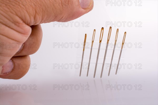 Six different sewing needles isolated on a white background