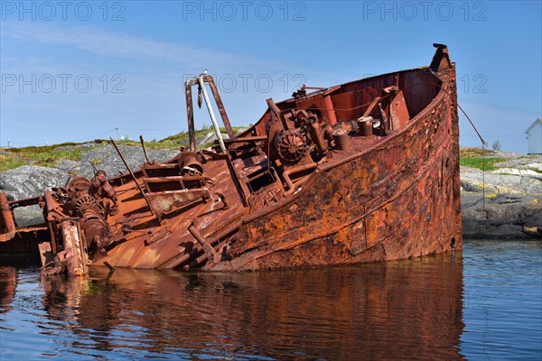 Rusty shipwreck on the Atlantic Strait in Norway