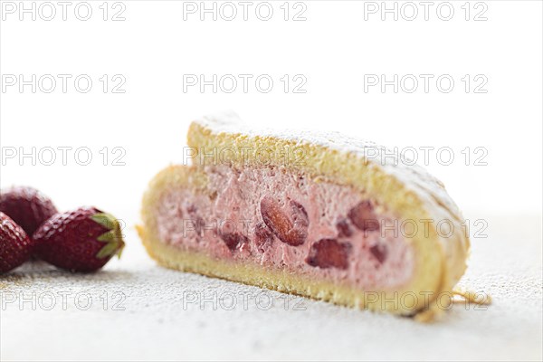 Delicious fruity sponge roll with strawberry filling Strawberry Quark Sponge Roll sprinkled with icing sugar